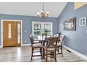 Bright dining room with a large window, stylish table set, and modern flooring at 365 Kinder Rd, Harmony, NC 28634
