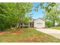 Traditional home with a cozy front porch, attached garage, driveway and a mature trees on a lush green lawn at 3790 Lynnview Ct, Maiden, NC 28650