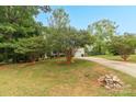 Traditional home with a cozy front porch, attached garage, and a mature trees on a lush green lawn at 3790 Lynnview Ct, Maiden, NC 28650