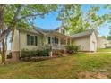 Traditional home with a cozy front porch, attached garage, beautifully landscaped yard with mature trees at 3790 Lynnview Ct, Maiden, NC 28650