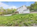 Exterior view of backyard with pool and large yard, storage shed, and forest at 380 Hamrick Rd # 1, Gastonia, NC 28056