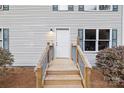 Front door with small porch, steps, gray siding, shutters, and a trimmed yard at 380 Hamrick Rd # 1, Gastonia, NC 28056