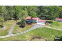 Spacious home with a red roof, an extended driveway, and a large front yard at 4205 Cahnnas Way, Waxhaw, NC 28173