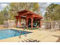 Backyard inground pool with a wooden pergola, comfortable seating, and a relaxing ambiance at 424 Mirror Lake Rd, Salisbury, NC 28146