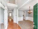 Bright entryway with hardwood floors, carpet, a chandelier, and views into the living and dining areas at 431 Harvest Ter, Lake Wylie, SC 29710