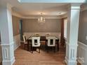 Dining room with hardwood floors, white trim, wainscoting and an elegant chandelier at 5025 Wicklow Dr, Gastonia, NC 28054