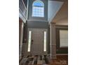 Welcoming foyer with high ceilings, large window, and hardwood floors at 5025 Wicklow Dr, Gastonia, NC 28054