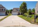 Traditional two-story home with a long driveway, attached garage, and well-manicured front lawn at 5102 Candleglow Ct, Indian Trail, NC 28079