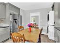 Open kitchen and dining area with stainless steel refrigerator and stacked washer/dryer at 534 Georgia Ave, Statesville, NC 28677