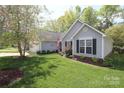 Beautiful single-story home showcasing well-kept lawn and landscaping with a detached garage at 7515 Shadowstone Dr, Charlotte, NC 28270