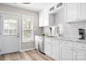 Modern white kitchen with stainless steel appliances and plenty of counter space at 7910 Camden Hollow Rd, Huntersville, NC 28078