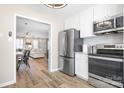 Well-equipped kitchen with stainless steel refrigerator and an open view to the living area at 7910 Camden Hollow Rd, Huntersville, NC 28078