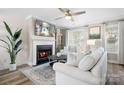 Cozy living room with a fireplace, plush seating, and ample natural light at 7910 Camden Hollow Rd, Huntersville, NC 28078