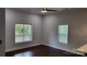 Bright living room featuring hardwood floors, a ceiling fan, and natural light from two windows at 925 14Th St, Lancaster, SC 29720