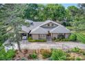 Aerial view of a landscaped home with a carport and swing at 10315 Washam Potts Rd, Cornelius, NC 28031