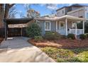 Bungalow features carport, welcoming front porch, and manicured landscaping at 106 N Turner Ave, Charlotte, NC 28216