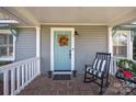 Inviting front porch with rocking chair and autumn wreath on the door at 106 N Turner Ave, Charlotte, NC 28216
