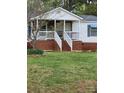 Charming home with a welcoming front porch, brick accents, well-manicured lawn, and cozy curb appeal at 1110 Hollyberry Ln, Salisbury, NC 28147