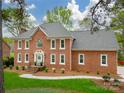 Handsome brick home showcasing manicured lawn, stately facade and white trimmed windows at 1176 Fawn Ridge Nw Rd, Concord, NC 28027