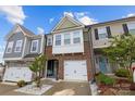 Charming townhome featuring brick facade, white garage door, and a well-manicured front yard at 1245 Pebble Grove Dr, Clover, SC 29710