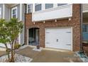 Brick front townhome featuring a garage and arched entryway sitting area at 1245 Pebble Grove Dr, Clover, SC 29710