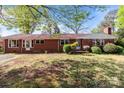 Cozy one-story brick home featuring a well-kept lawn and traditional design elements at 1315 Arbor Dr, Salisbury, NC 28144