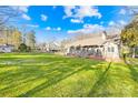 Expansive backyard with lush green lawn and mature trees, perfect for outdoor activities and entertaining at 13924 Island Dr, Huntersville, NC 28078