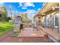 Inviting outdoor patio with a stone fireplace, seating area, and ample space for relaxation and entertaining at 13924 Island Dr, Huntersville, NC 28078