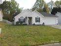 Well-maintained single-story home with a green lawn, and welcoming front entrance at 158 Margaret Turner Rd, Charlotte, NC 28216