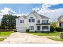 Inviting two-story home with a manicured lawn, attached garage, and a charming front porch at 17309 Knoxwood Dr, Huntersville, NC 28078