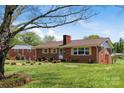 Lovely brick home with well-manicured lawn and mature trees providing a serene backdrop at 175 Neita Dr, Salisbury, NC 28147
