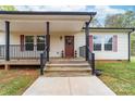 Welcoming front entrance with a charming porch and manicured landscaping at 1957 Beth Haven Church Rd, Denver, NC 28037