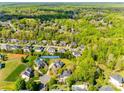 Scenic aerial view of a lush neighborhood showcasing mature trees and well-maintained homes, including the property at 2004 Ptarmigan Ct, Waxhaw, NC 28173