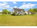 Charming single-story home featuring a well-manicured lawn, classic shutters, and mature trees at 203 Ackert Ave, Salisbury, NC 28144