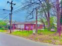 Brick home with a fenced in yard and detached garage at the end of the driveway at 204 Lloyd St, Salisbury, NC 28144