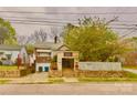 Brick home with front entrance steps leading to a small porch area and a fenced in yard at 204 Lloyd St, Salisbury, NC 28144