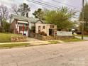 A home with a brick exterior and landscaping in need of some TLC from the street view at 204 Lloyd St, Salisbury, NC 28144
