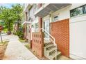 Close-up of the brick entrance with steps, a white railing, and glass door at 2094 Euclid Ave, Charlotte, NC 28203
