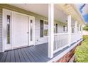 Covered front porch with grey floors and white columns at 2811 Saint James Church Rd, Denver, NC 28037