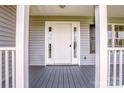 Inviting front porch with grey wood flooring and bright white trim at 2811 Saint James Church Rd, Denver, NC 28037