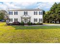 Charming two-story home with a manicured lawn, black shutters, and a welcoming front porch at 311 Cooks Lake Rd, Gastonia, NC 28056