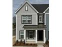 Attractive two-story townhome showcasing neutral siding, black trim, and covered front porch entry at 4004 Crooked Spruce Ct, Matthews, NC 28105