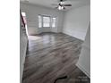 Spacious living room featuring new gray flooring, fresh paint, and ample natural light at 405 N Wilson St # 101, Rock Hill, SC 29730