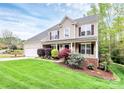 Attractive two-story home featuring a well-kept lawn and diverse landscaping with an attached two-car garage at 4086 Buckingham Dr, Fort Mill, SC 29707