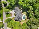 Expansive estate showcasing a pool, luxurious backyard, circular driveway, and mature trees at 5001 Oxfordshire Rd, Waxhaw, NC 28173