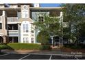 Charming blue condo with balconies, complemented by mature trees and professional landscaping at 501 Olmsted Park Pl # N, Charlotte, NC 28203