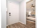 Inviting foyer with hardwood floors leading to a bedroom, featuring a white door at 501 Olmsted Park Pl # N, Charlotte, NC 28203