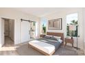 Airy bedroom with light wood floors, a barn door to the ensuite, and natural light at 548 Rountree Rd # 9, Charlotte, NC 28217