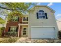 Charming two-story home with brick and vinyl siding, attached garage, and well-maintained front yard at 5713 Falkirk Ln, Matthews, NC 28104