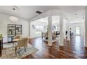 Spacious living room with hardwood floors, neutral tones, and architectural columns for an open feel at 5713 Falkirk Ln, Matthews, NC 28104